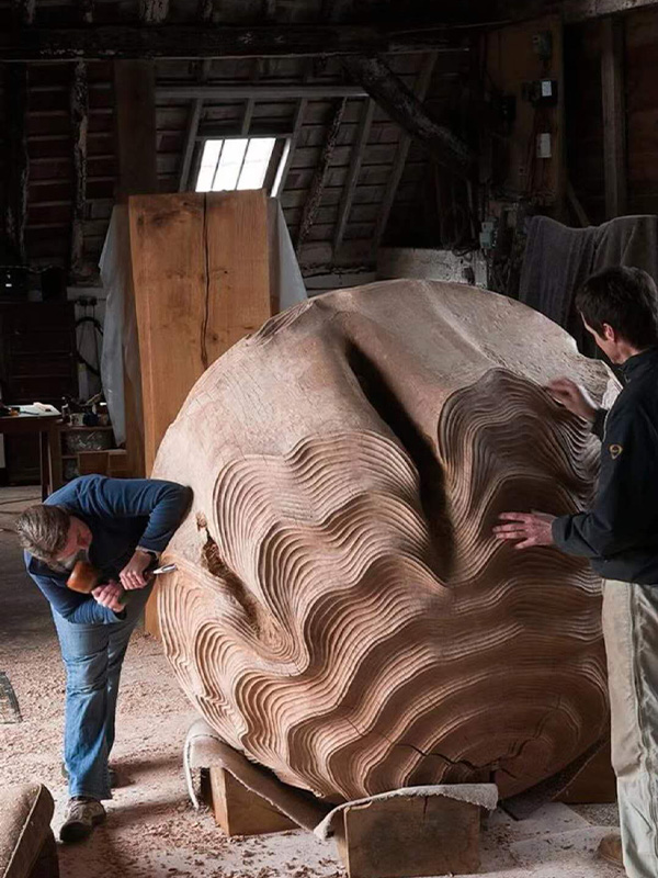 Wood carved spherical sculpture